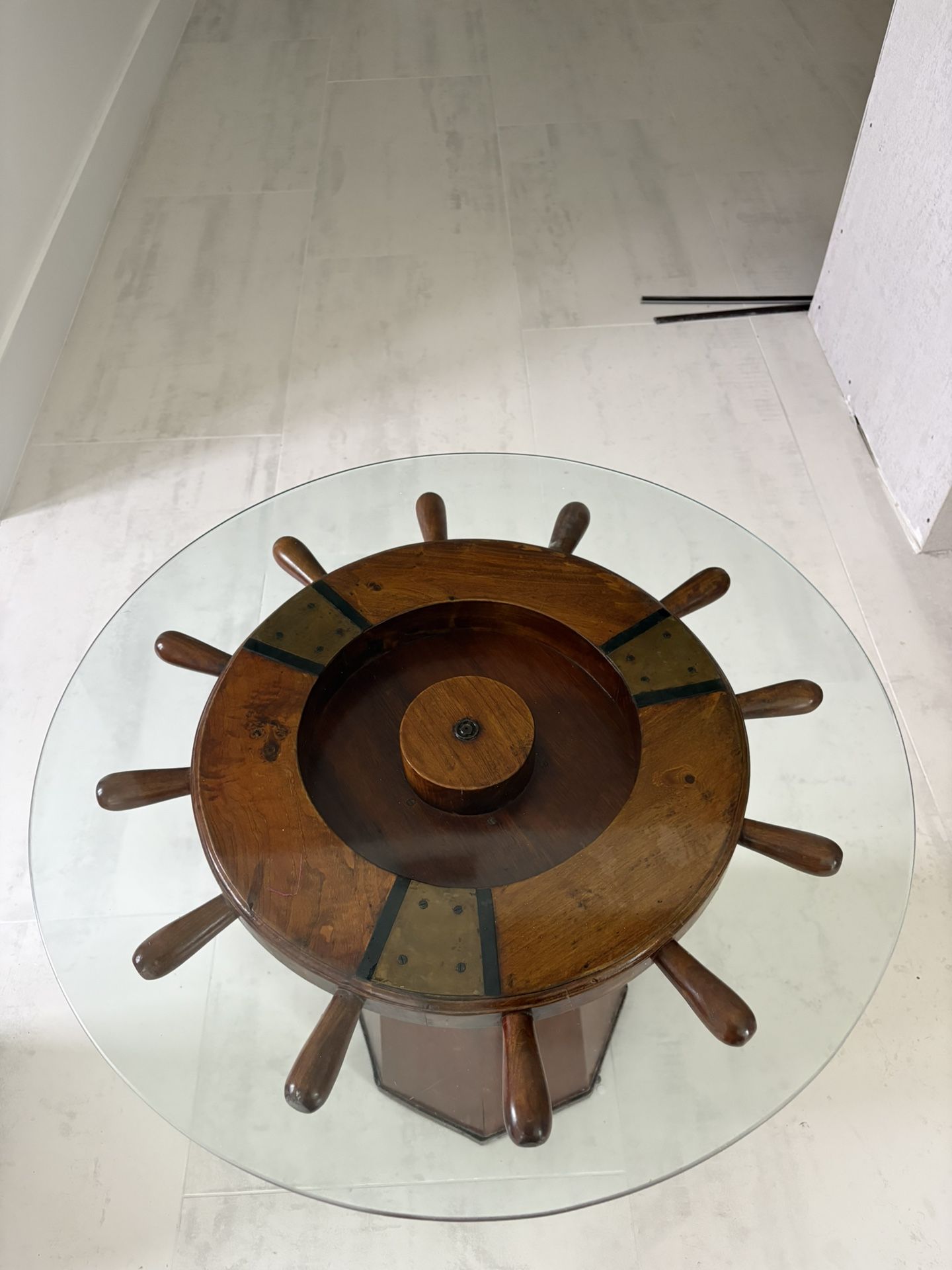 Nautical ship wheel glass-top table.
