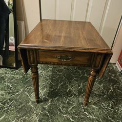Real wood end table/coffee table with lift up sides and one pull out drawer. 