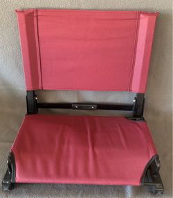 folding stadium seat features yellow screen-printed lettering for "TPHS LACROSSE" on the backrest  - burgundy and gold
