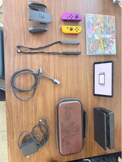 Nintendo Switch OLED, Nintendo Switch dock, power cord and hdmi, 2 games, purple and orange joysticks with controller and joycon wrist wraps