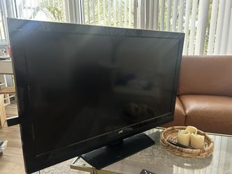 Tv With Fire tv stick And Two Remotes