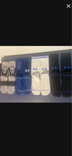 4 Pairs Under Armour socks and 1 fitted Under Armour shirt for boys
