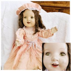 Antique 28" Compositon Doll with Peach Pink Dress and Hat, White Slip On Shoes and Petticoat Cotton Lining. She has Articulating Arms, Legs and Head a