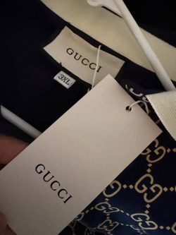Gucci men's polo shirt features an all-over navy blue and cream GG monogram pattern.