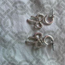 silver dangly bow earrings 