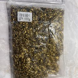 gold-colored skull-shaped necklace pendant