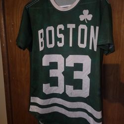  green Boston Celtics #33 mesh jersey features a unique short-sleeve styling with a shamrock graphic and wave hem detail