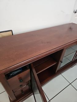 Cherry Wood TV Stand with Glass Doors and Drawers.