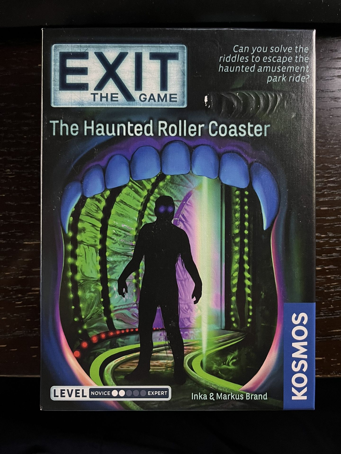 EXIT: The Haunted House Game EXIT: The Game is a series of escape room games for the home. Players must solve riddles and puzzles and crack codes to e