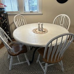Heavy wooden table with metal base and four chairs