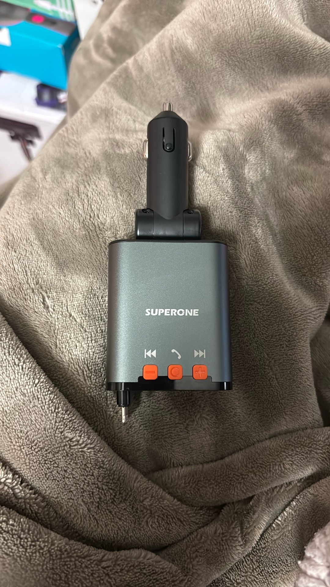 The product in the image is a SUPERONE Bluetooth car charger with an FM transmitter.