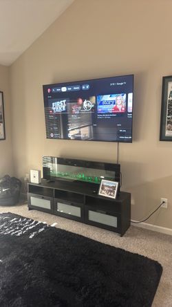 Large Flat Screen TV Wall Mounted- fire place and tv stand