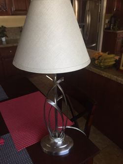Nicely designed chrome lamp with shade. Approximately 26 inches in height.