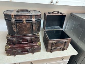 set of modern decorative storage boxes styled as vintage leather suitcases.