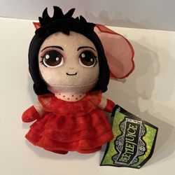 Jazwares Warner Bros. Beetlejuice Lydia Deetz plush doll.  This 8-inch collectible plush features Lydia in her iconic red wedding dress and Gothic att