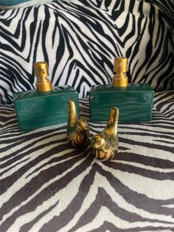Two ceramic soap dispensers and gold toned ceramic