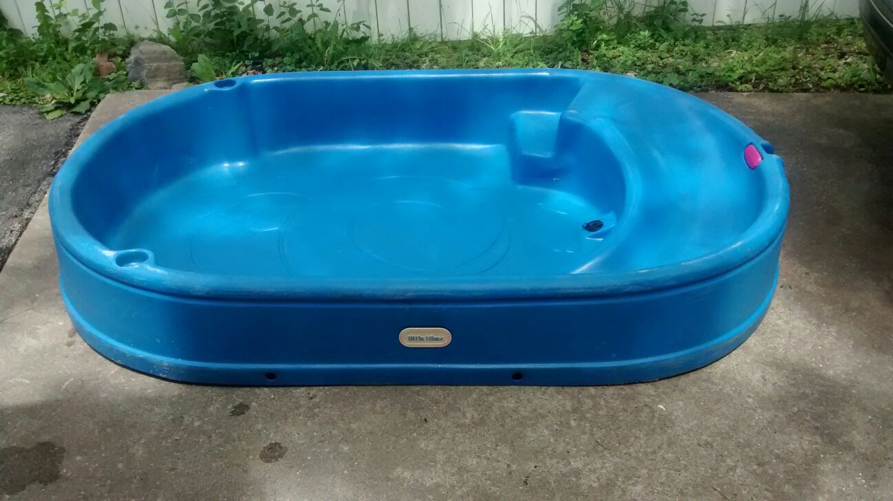 Little Tikes plastic pool with built-in slide, cup holders and attached sprinkler