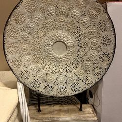 White metal carved mandala art on stand. H 20” width 16” 