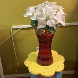 Red Plastic Vase With White Artificial Flowers