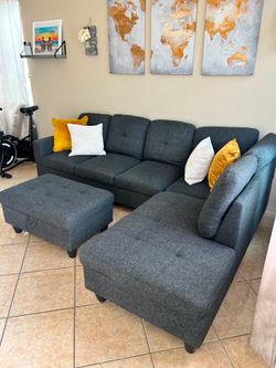 Beautiful charcoal grey sectional couch with storage ottoman
