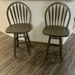 Two Gray swivel bar stools. Slight damage from hitting the counter.