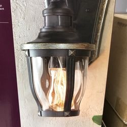 Home Decorators Collection McCarthy 1-Light Bronze with Gold Highlights Motion Sensing Outdoor Wall Mount Lantern