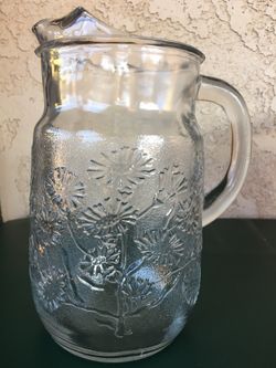 Clear glass pitcher with flowers