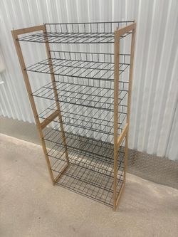 Pair of freestanding shoe racks with four tears with light wood frames and black wire shelves. Stackable.