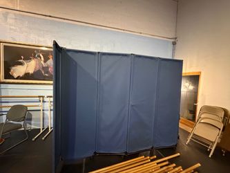 Blue fabric folding room divider on wheels