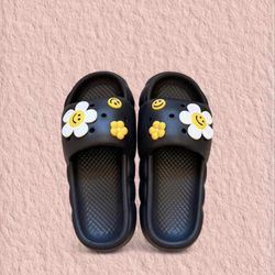 Black women slides with yellow and white smiley flower decorations size 6 to 7