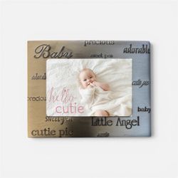 Fetco Accents pewter picture frame is designed for a 5" x 3.5" photo and features etched baby-themed words like "adorable" and "precious".