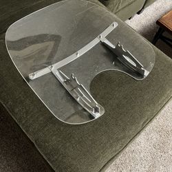 detachable motorcycle windshield with polished metal braces. 