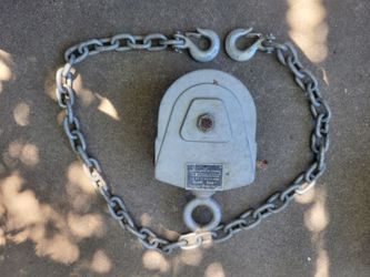 vintage industrial pulley block (often part of a block and tackle system) with a rated capacity of 3,000 lbs.