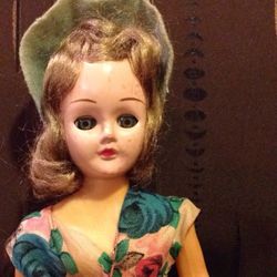 Beautiful antique doll with silk dress