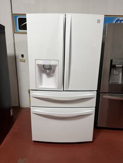 Kenmore 4-door refrigerator with water and ice dispenser, working perfectly. Dimensions: 35 3/4(W) x 39 1/8(D) x 70 1/4(H). Home delivery and installa
