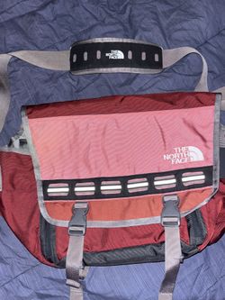 The North Face Base Camp Messenger bag (large size) with reflective stripes on the front flap and a padded shoulder strap