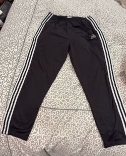 Adidas white side stripes and button up snaps along the legs. Adults size L