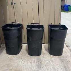 Three Black Wheeled Trash Cans