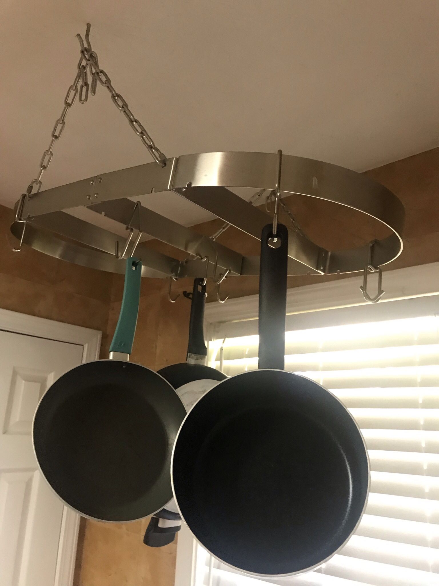 Chrome Hanging Pots And Pans attaches To The Ceiling 