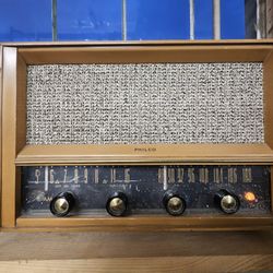 Vintage Philco AM/FM tabletop radio from the late 1950s. Solid mid-century wood cabinet with original grille cloth and knobs.