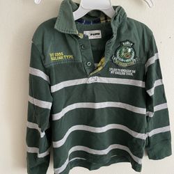 This is a long-sleeved rugby shirt for children. It features a very typical "college style" or "British style" design. • Color and pattern: The base c