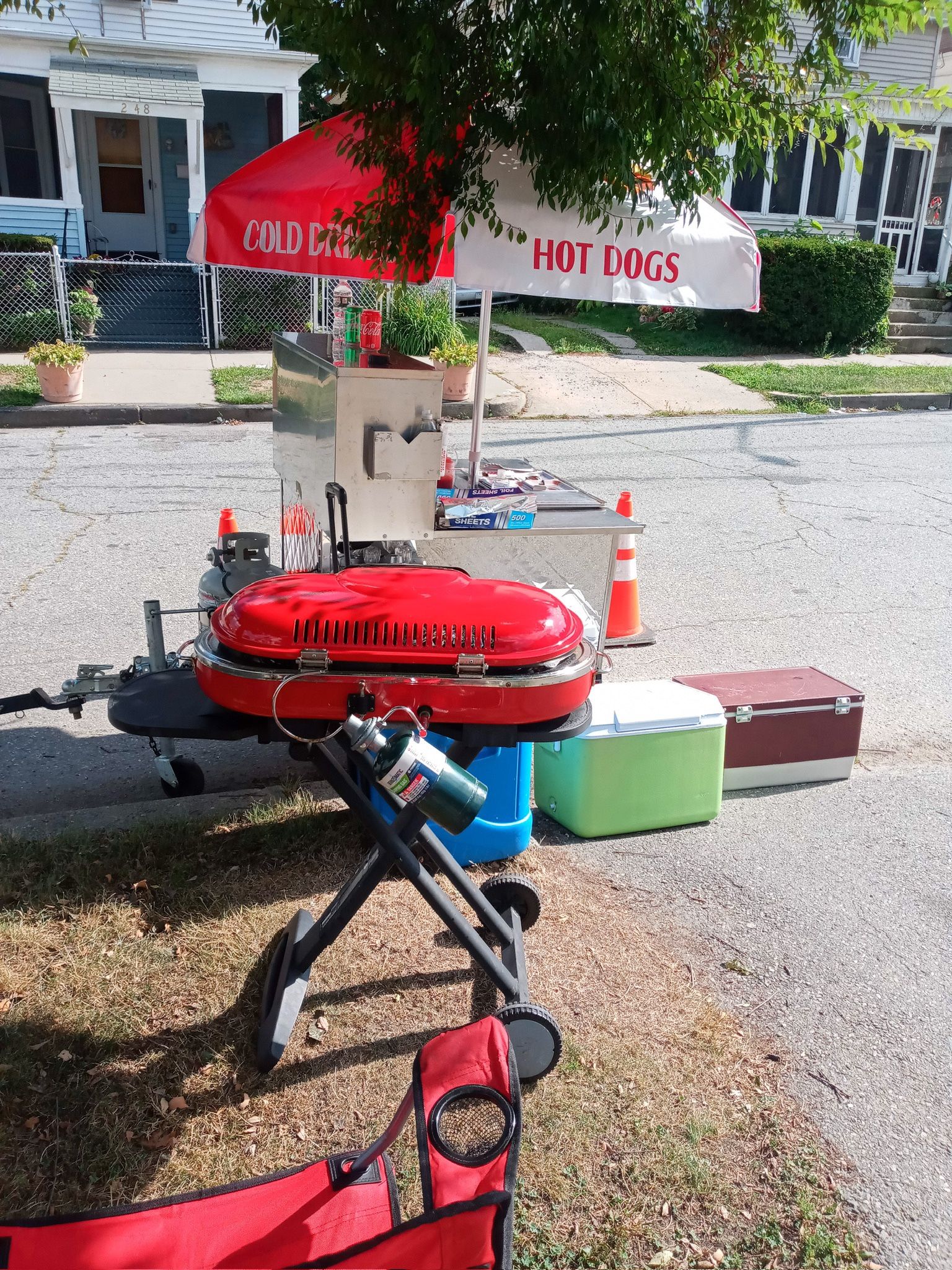 Hot cart with two burners, umbrella, and utensils pans the grill two grills and a ice cream cart with the wheels and brackets for umbrell 