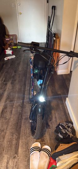 Electric seated scooter