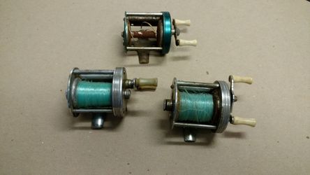 Three old fishing reels