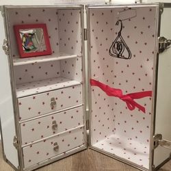 This American Girl Molly's Trunk is a must-have for any collector or fan of the popular doll line. The trunk, which is in good used condition, comes w