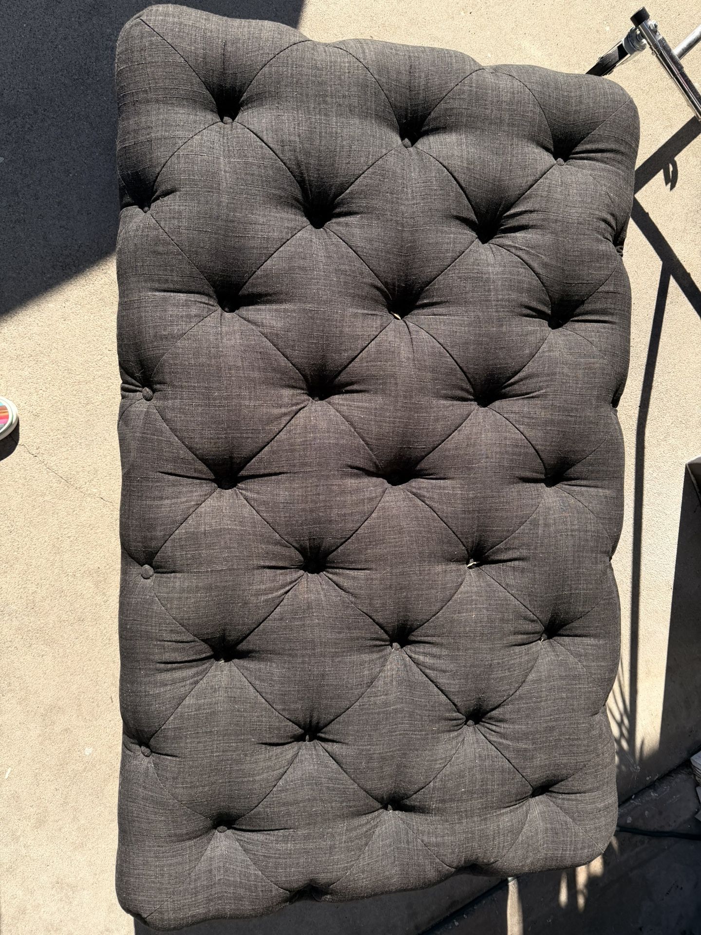 Grey quilted ottoman