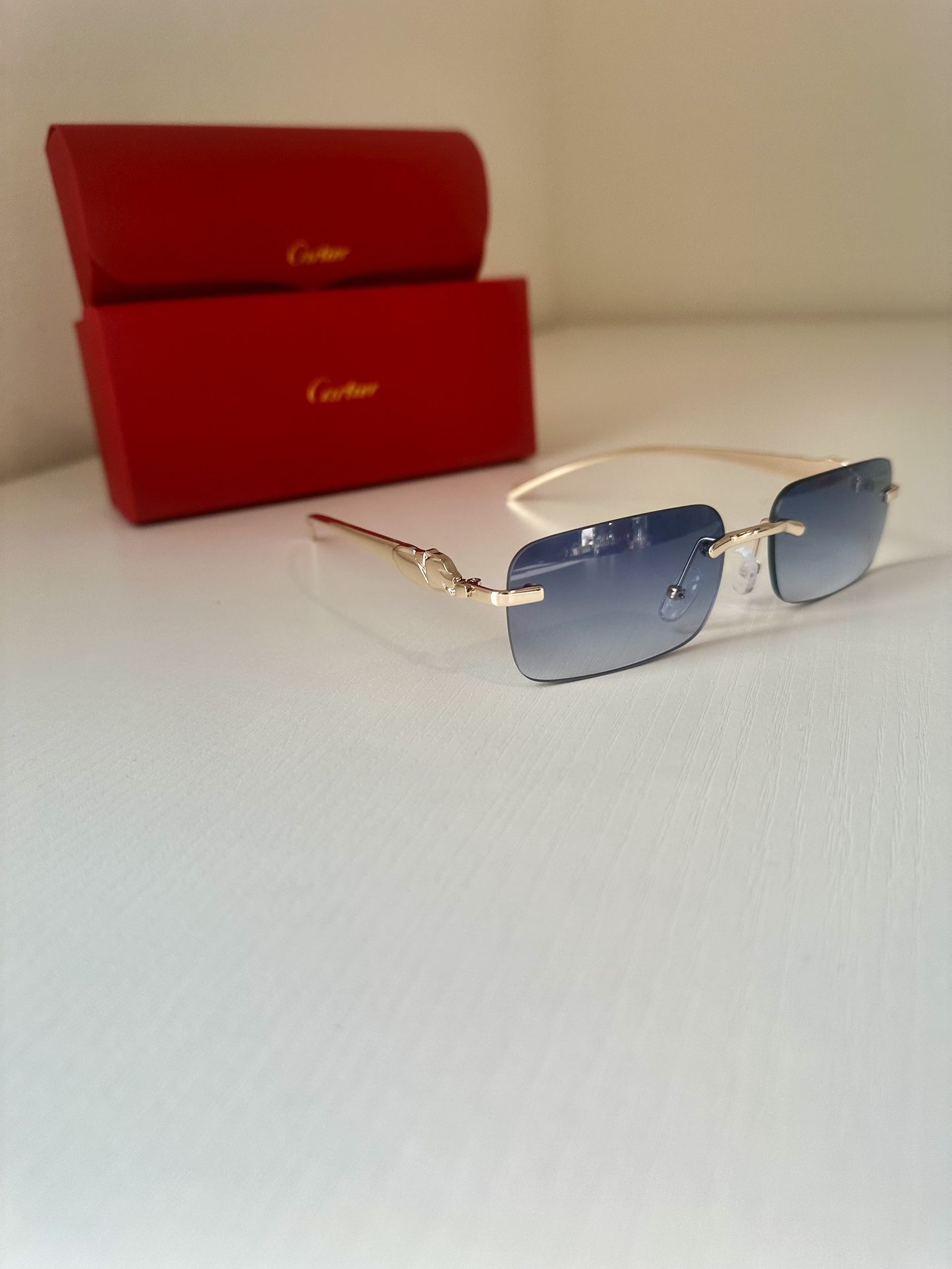 Blue Cartier sunglasses with gold frame
