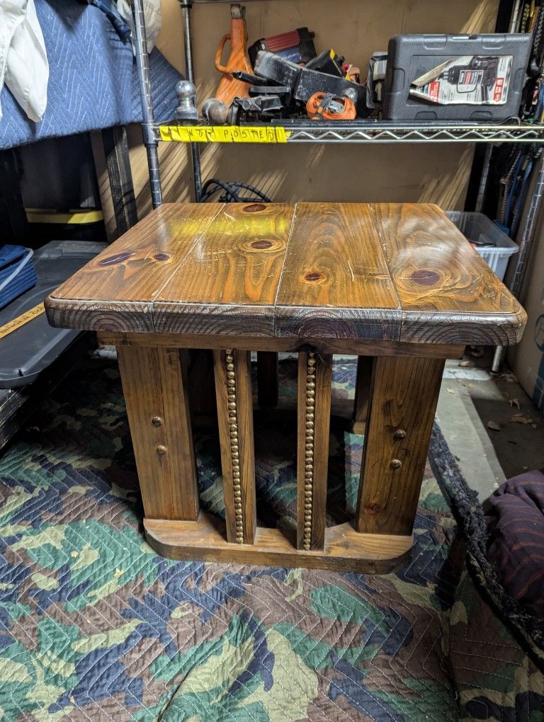 rustic wood end table with decorative studding on the leg