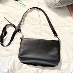 Black leather crossbody handbag with zip closure