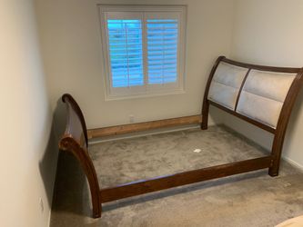 4 piece wood, sleigh style, queen size bed frame. With decorative head board.